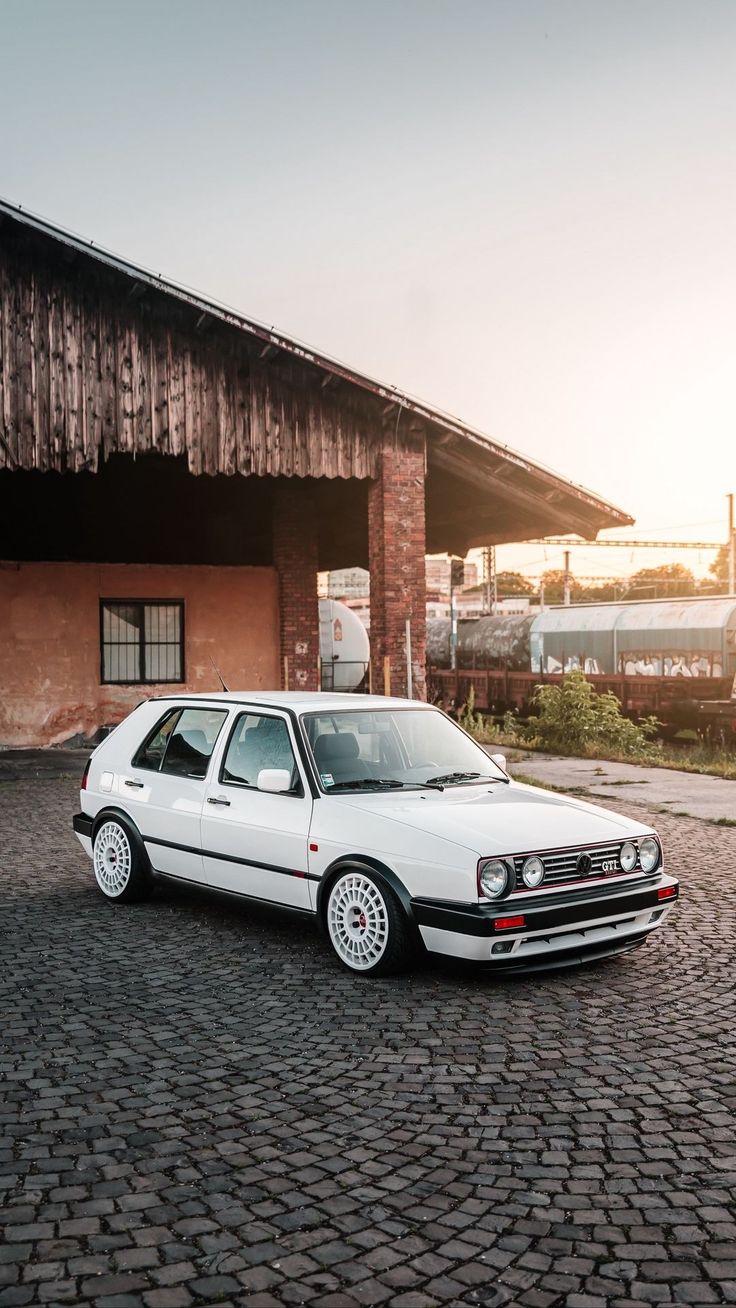 a white car parked in front of a building