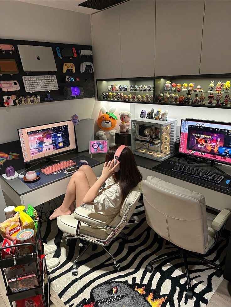 a woman sitting in a chair with a laptop on her lap and other computer equipment behind her