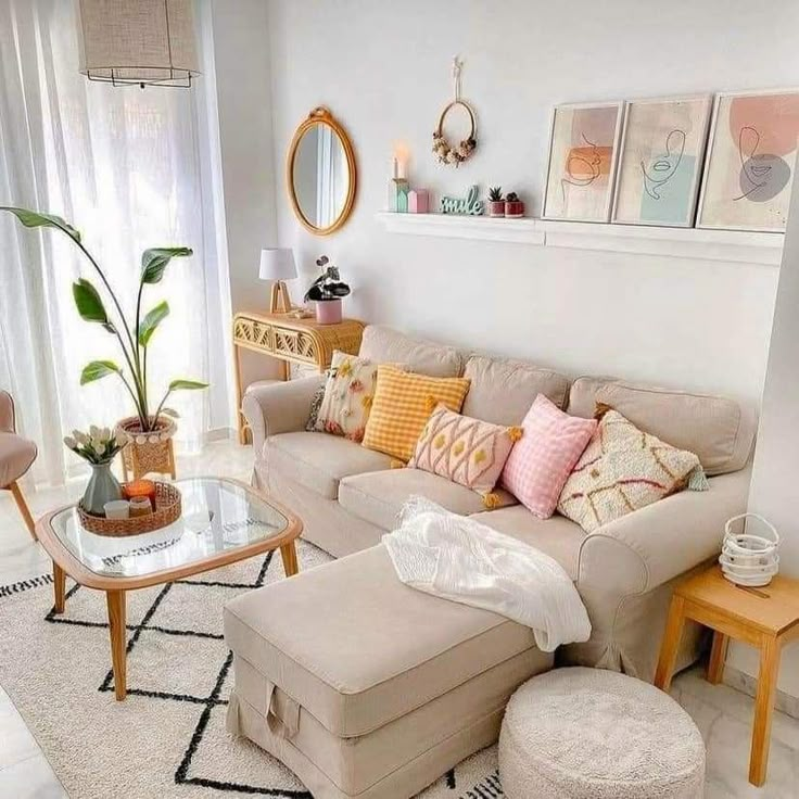 the living room is decorated in pastel colors and has white furniture with colorful pillows