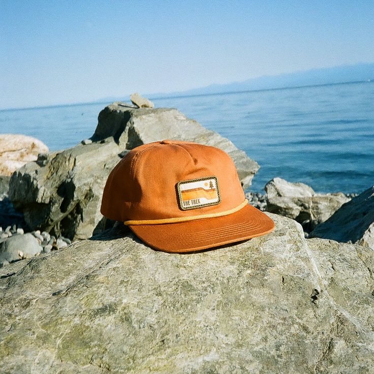 Meet The Trailbound Cap—a 100% cotton, flat-brim hat built for the trail and beyond. With a paracord band and two classic colors, Rust and Olive, this hat combines rugged durability with a clean, modern style. Whether you're out exploring or just keeping it casual, The Trailbound Cap has you covered. $1 of your purchase will be donated to the non-profits overseeing the Appalachian Trail (ATC), Pacific Crest Trail (PCTA), and the Continental Divide Trail (CDTC). For shipping and returns policy or Appalachian Style, Flat Brim Hats, Continental Divide Trail, The Appalachian Trail, Flat Brim Hat, Continental Divide, Pacific Crest Trail, Appalachian Trail, Clean Modern