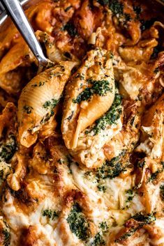 chicken and spinach casserole in a pan with a serving utensil