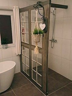 a bathroom with a tub, shower and window