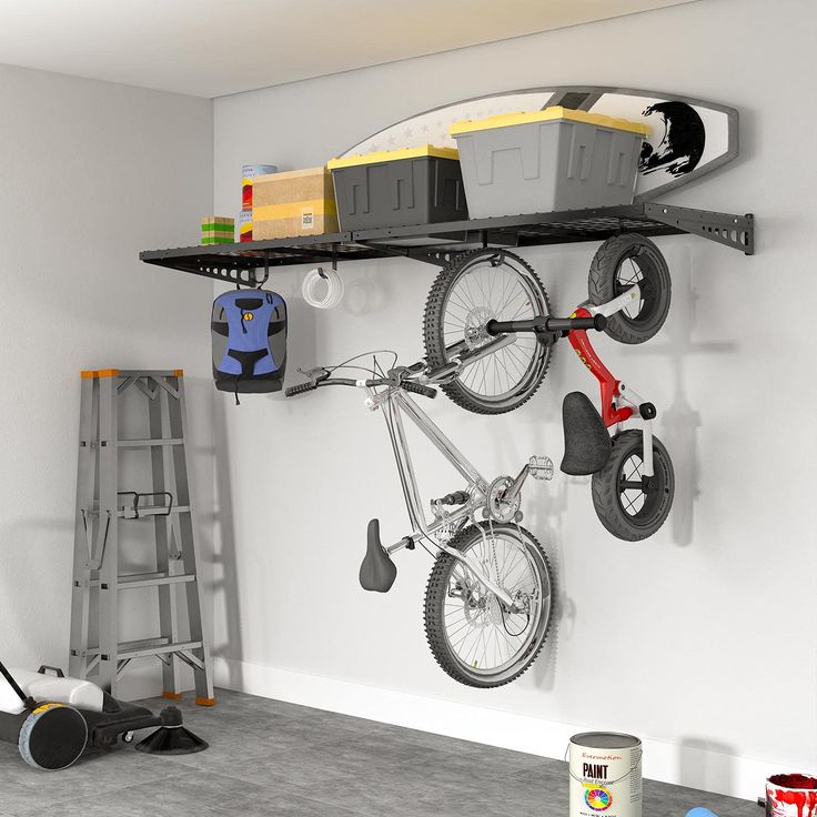 a bike hanging on the wall with other tools