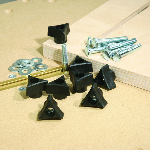 screws, nuts and bolts are laying on the floor next to a piece of wood