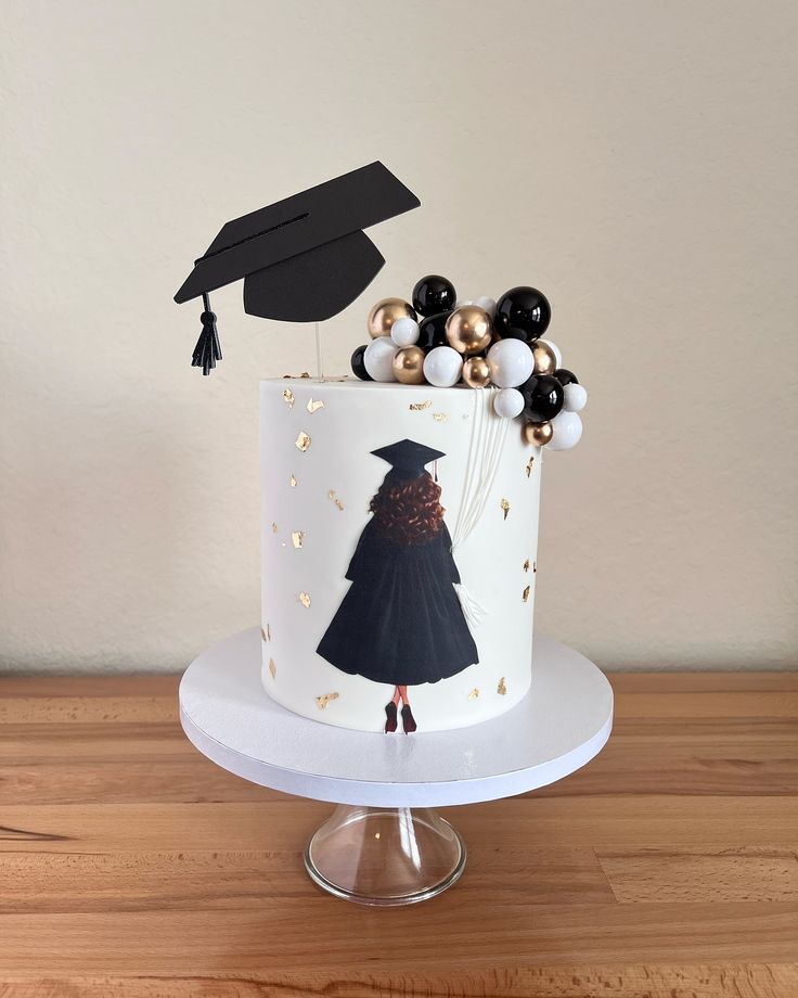 a decorated graduation cake sitting on top of a wooden table