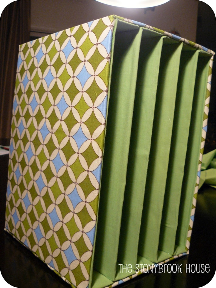 a green and blue box sitting on top of a table next to a white light