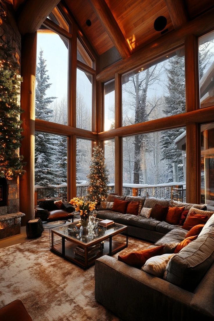 a living room filled with furniture and a christmas tree in the middle of the room