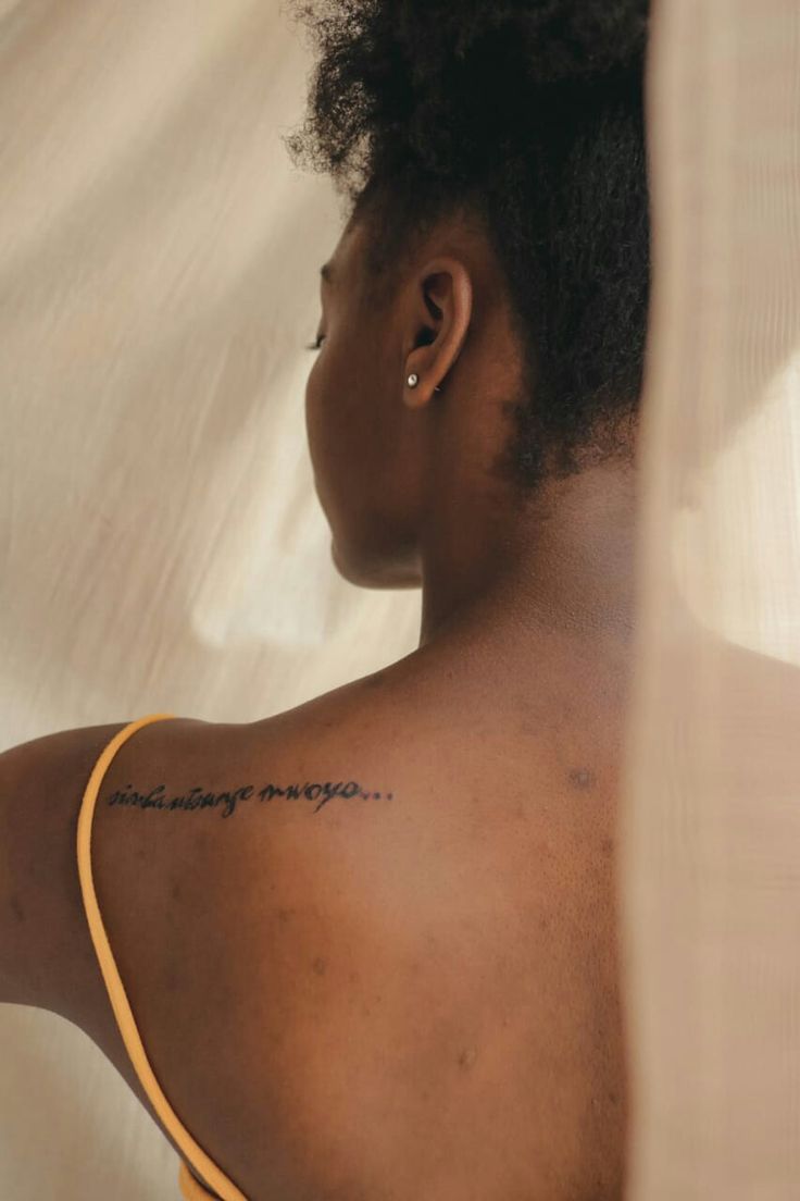 a woman with a tattoo on her back