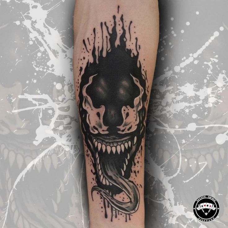 a black and white tattoo with an evil face