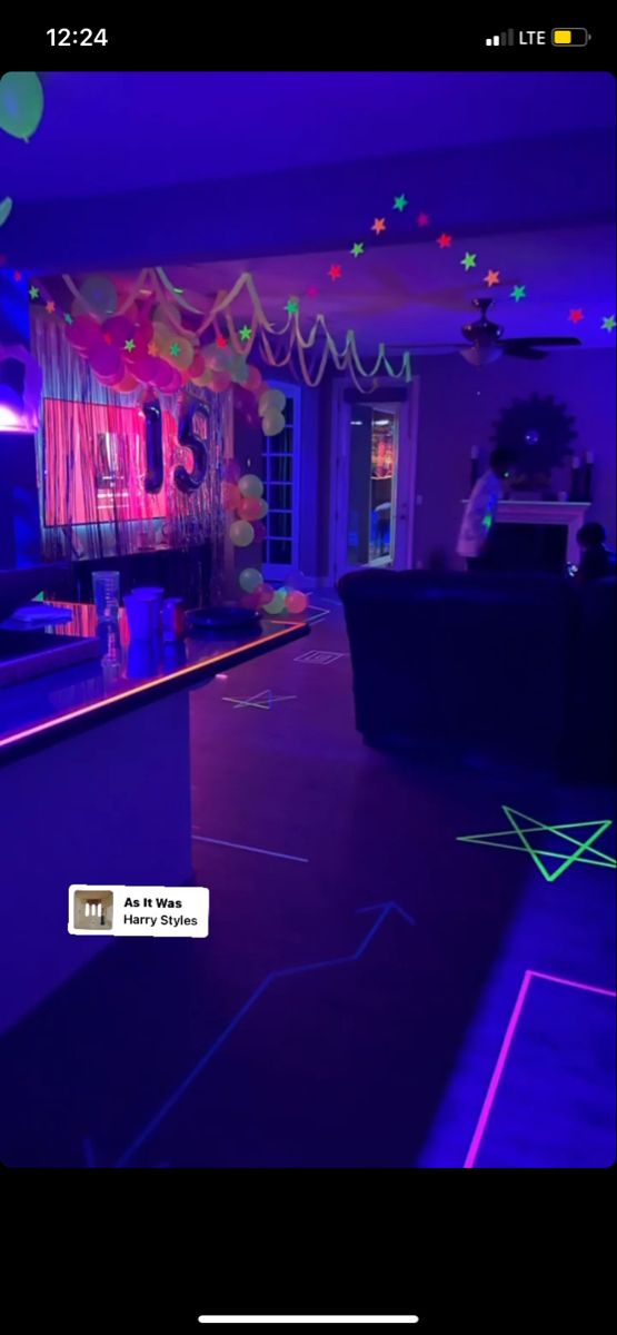 the room is decorated with neon lights and streamers