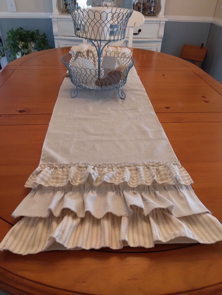 a table with a basket on top of it and some napkins in the middle