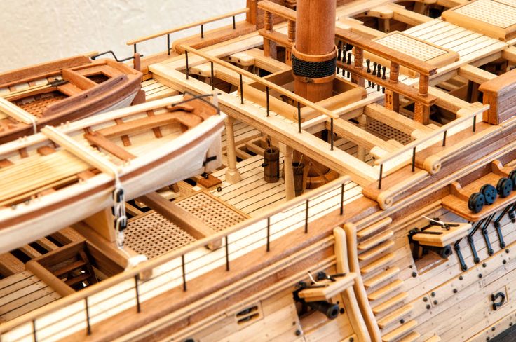 a wooden model of a sailing ship with lots of wood planks on the deck