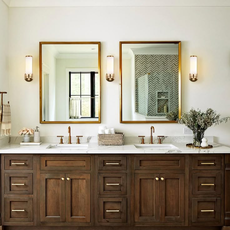 two mirrors are above the double sinks in this bathroom