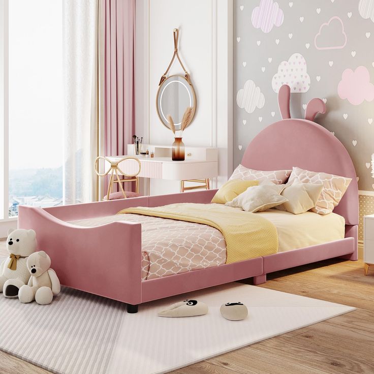 a child's bedroom with pink furniture and wallpaper, including a large bed