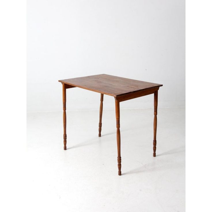 a wooden table sitting on top of a white floor