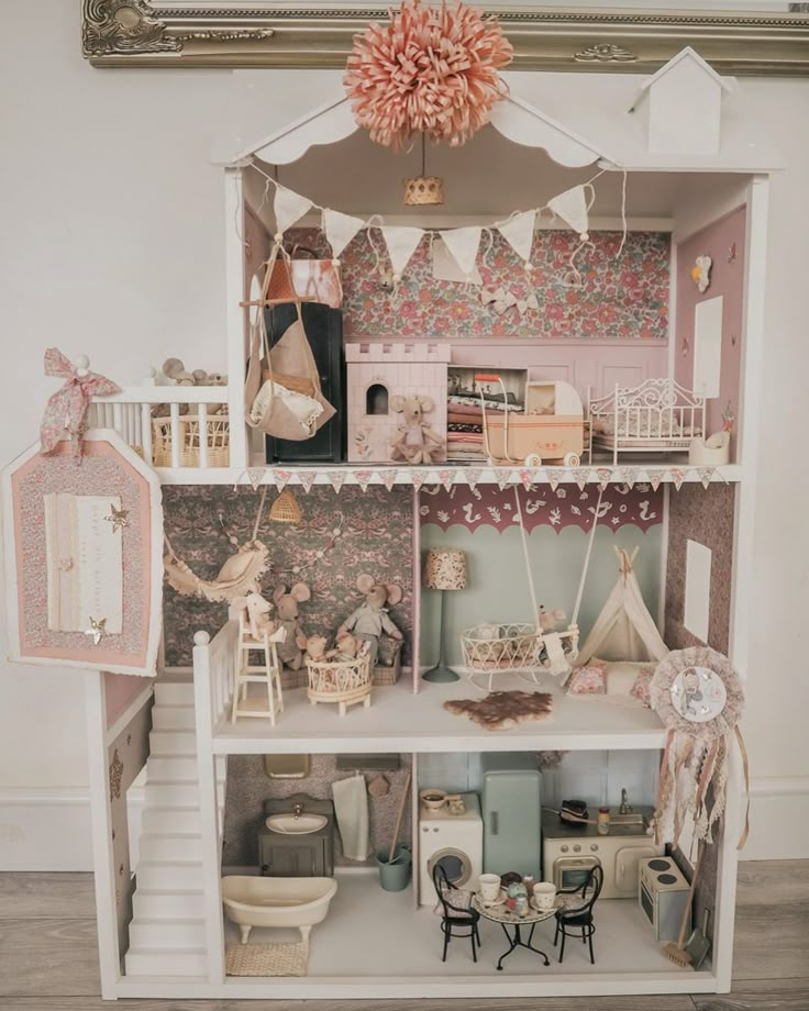 a doll house with furniture and accessories on display