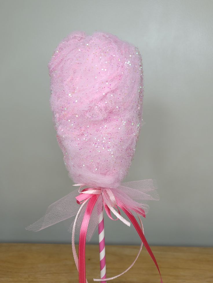 a candy lollipop with pink and white sprinkles