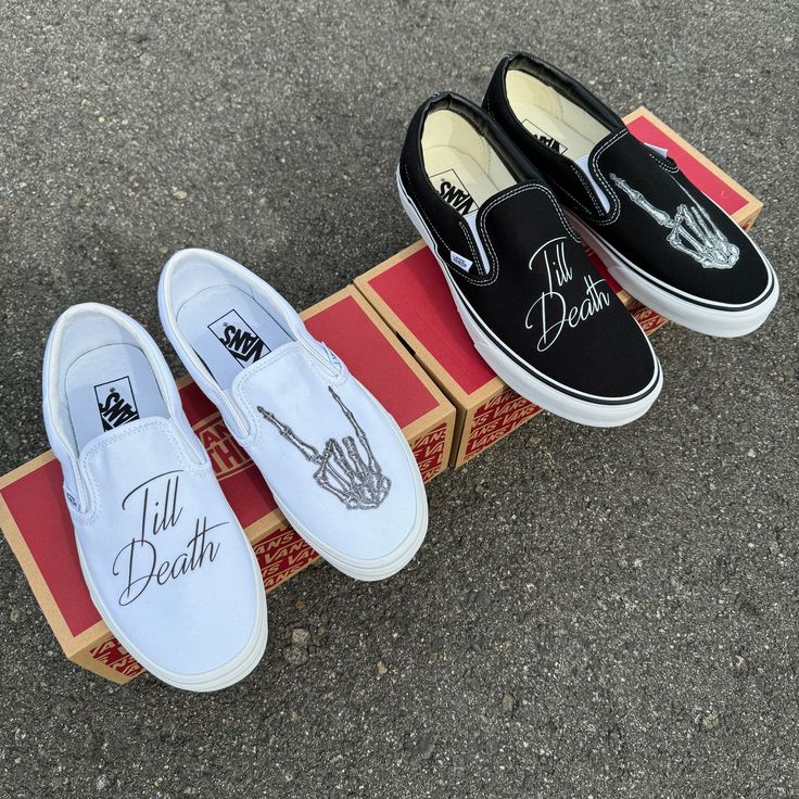 three pairs of black and white slip ons sitting on top of a box