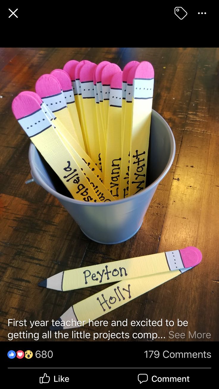 a bucket full of pencils sitting on top of a wooden table