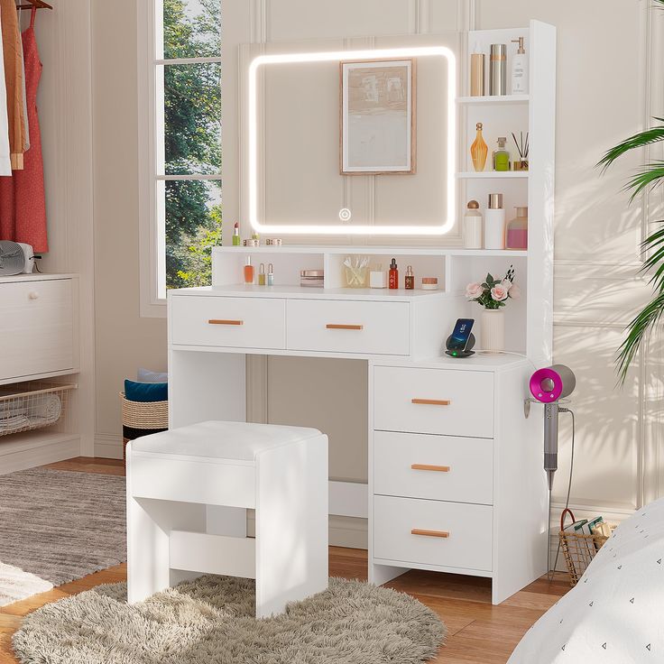 a white vanity with lighted mirror and stool