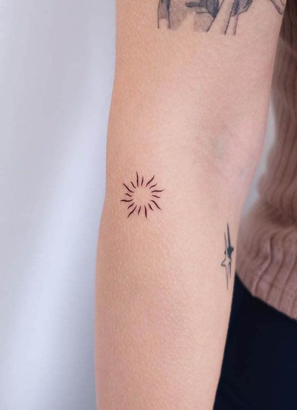 a woman with a small tattoo on her arm