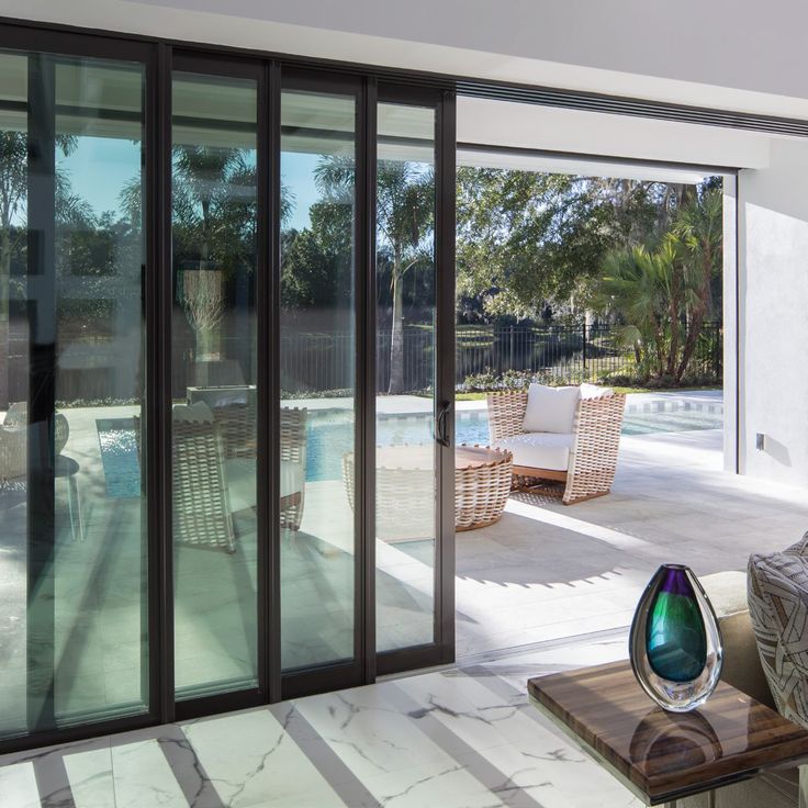 an outdoor living room with sliding glass doors