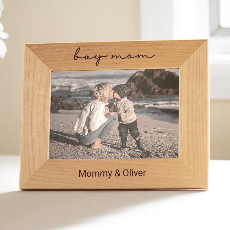 a wooden frame with a photo of two children kissing