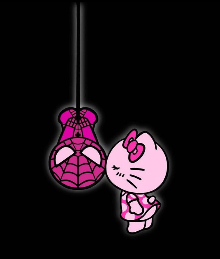 a hello kitty hanging from a string in the dark