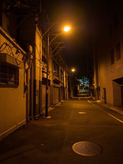 an empty street at night with lights on