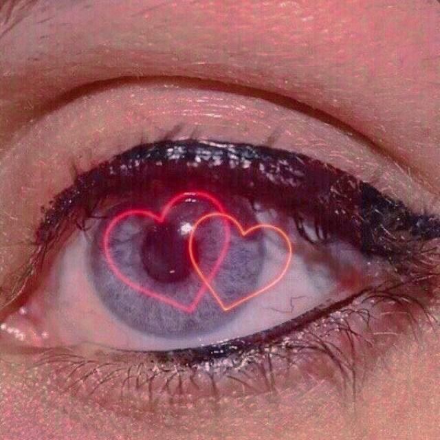 an eye with two hearts drawn on it's irise, and the reflection is in