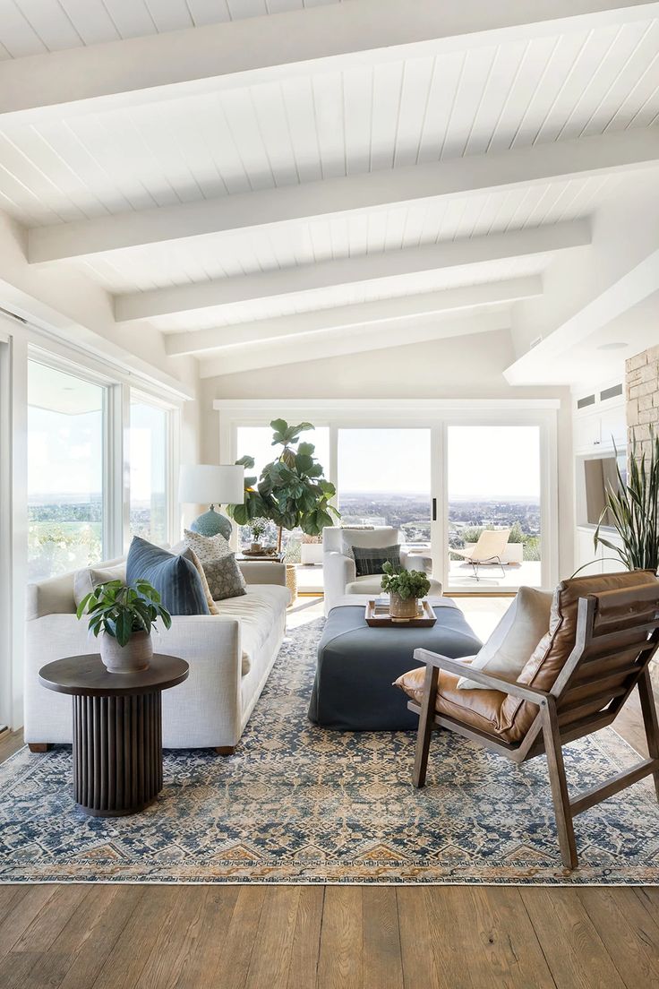 a living room filled with furniture and lots of windows