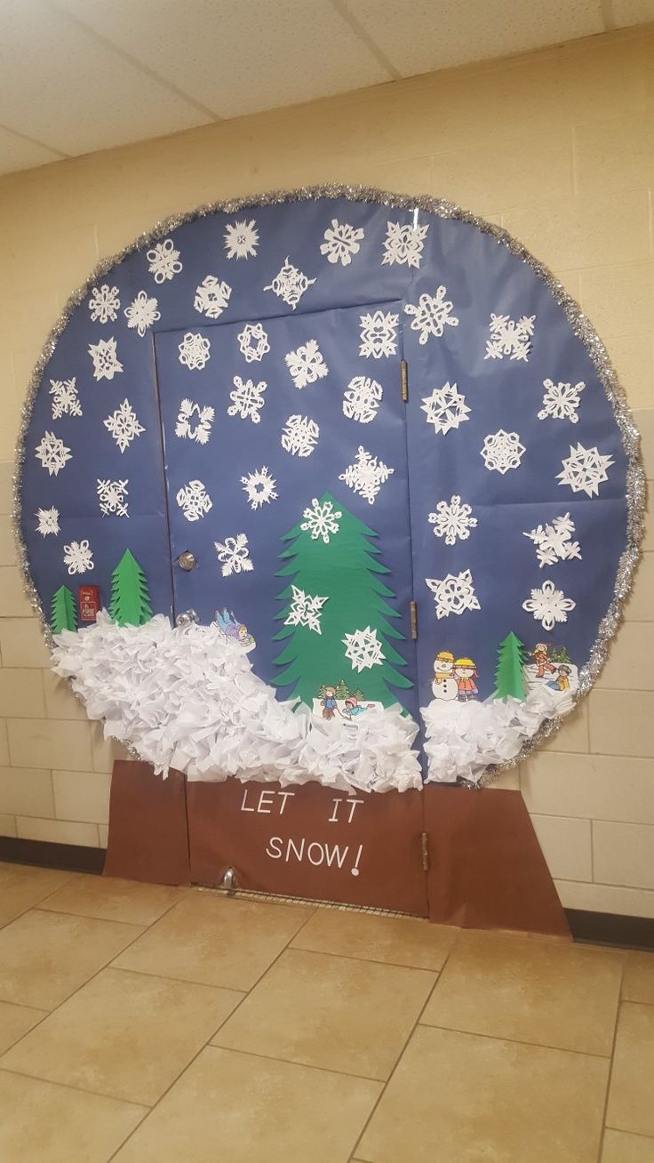 a bulletin board with snow and trees on it in the middle of a tiled floor