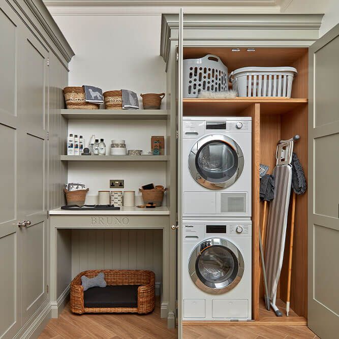 a washer and dryer sitting in a closet next to each other on shelves