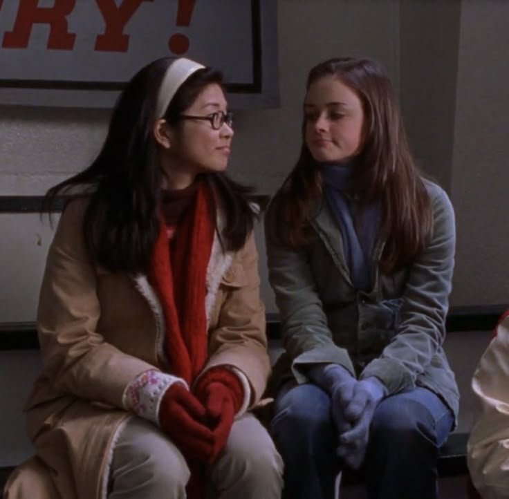 two young women sitting next to each other