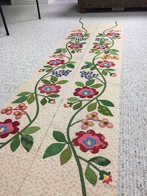 the floor is decorated with colorful flowers and green leaves, along with white carpeting