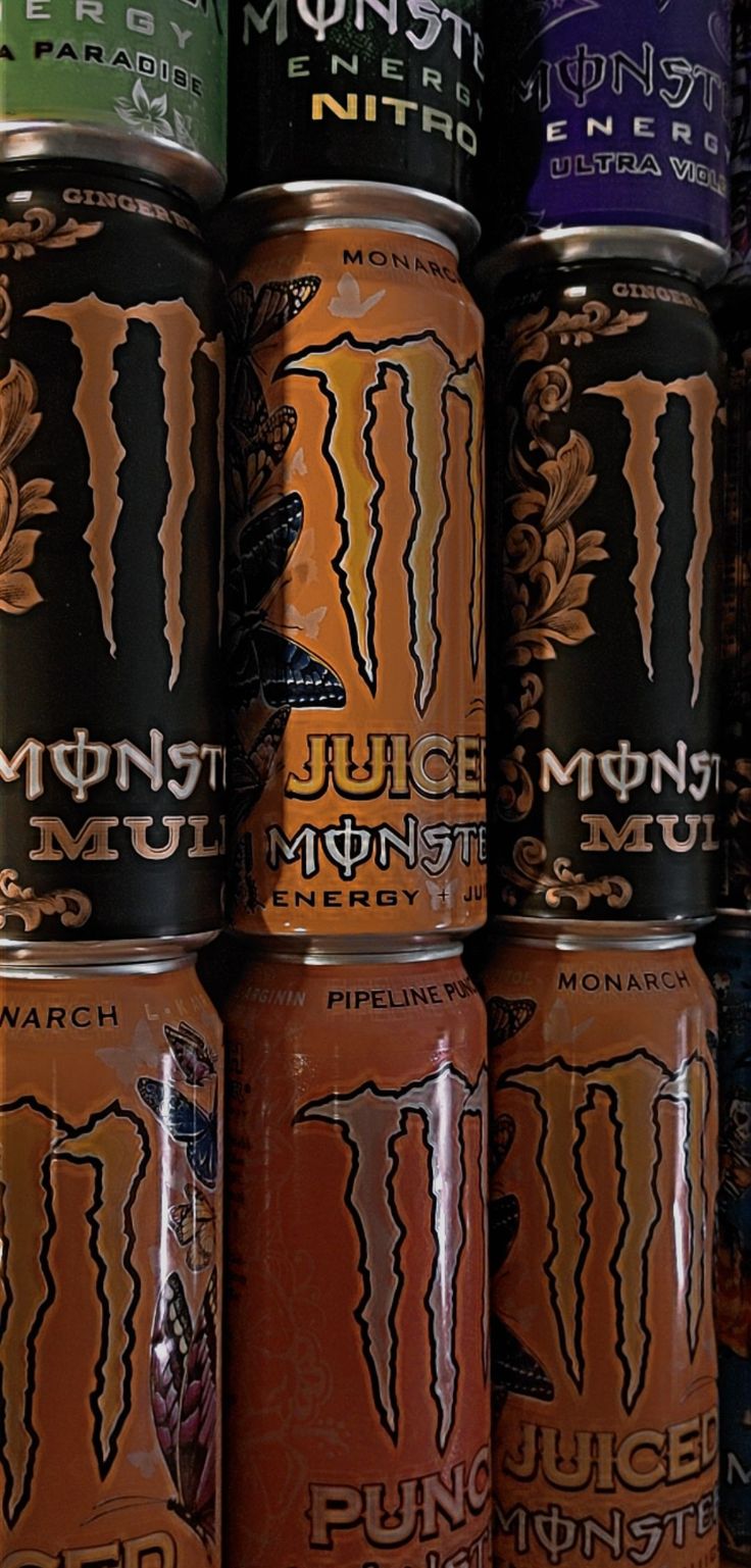 several cans of monster juice are stacked on top of each other