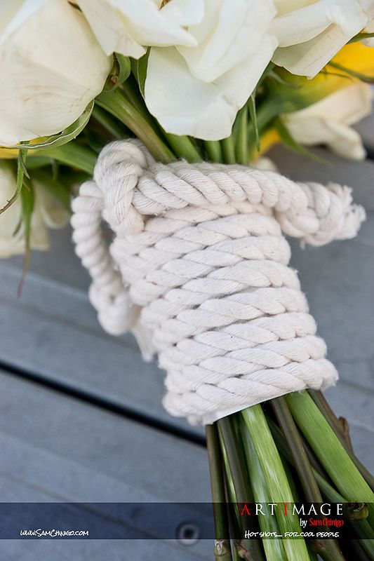 a bunch of flowers that are tied to some kind of rope on a table with an instagram message below