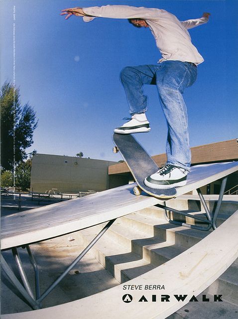 a man riding a skateboard up the side of a metal hand rail