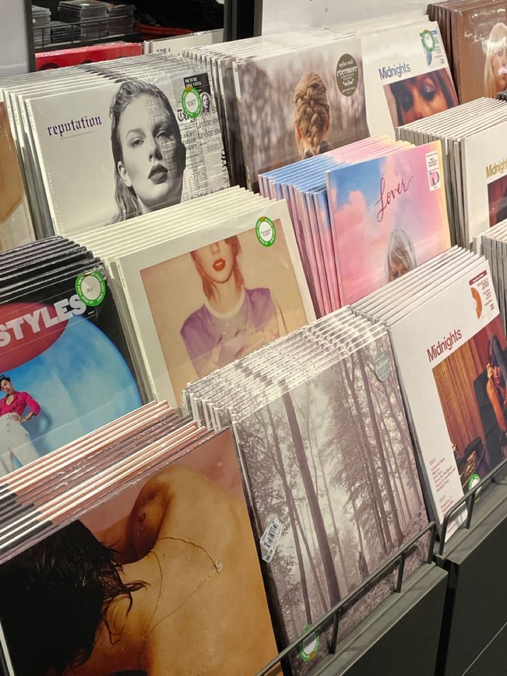 there are many cd's on display in the store, all different colors and sizes