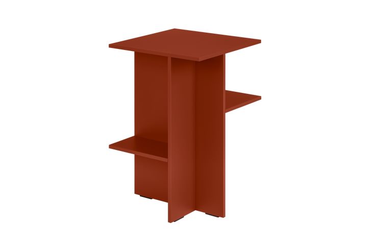 a red shelf sitting on top of a white wall