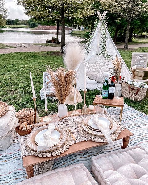 a picnic table set up with plates and place settings