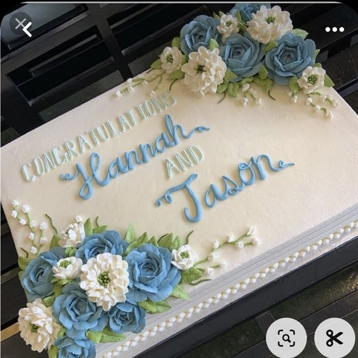 a cake with blue and white flowers on it that says congratulations to launch and jason