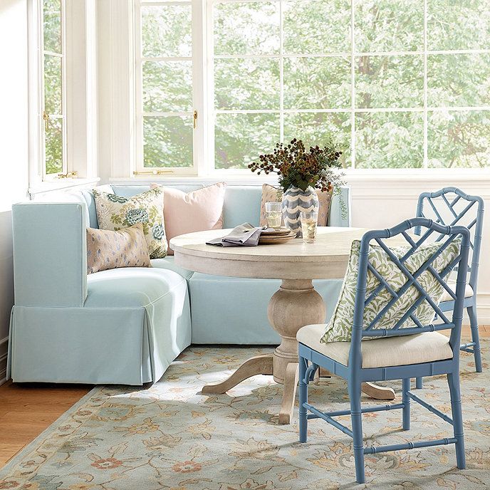 a living room filled with furniture next to a table and chairs in front of a window