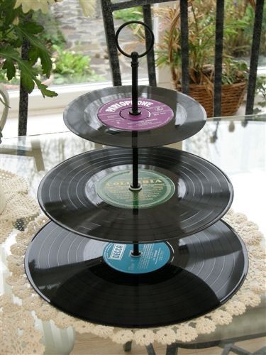 three tiered trays with vinyl records on them sitting on top of a table