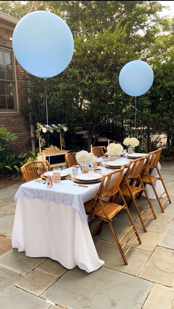 Garden party baby shower for a baby boy. Bamboo chairs, blue and white stripe table cloth, rattan cups, bamboo cutlery Boy Baby Shower Tea Party, Boy Tea Party Baby Shower Ideas, Baby Shower At Restaurant Ideas, Bonjour Baby Shower Ideas, Baby Boy Tea Party Shower Ideas, Baby Shower Restaurant Ideas, Old Money Baby Shower Theme, Baby Shower Aesthetic Boy, Poolside Baby Shower Ideas