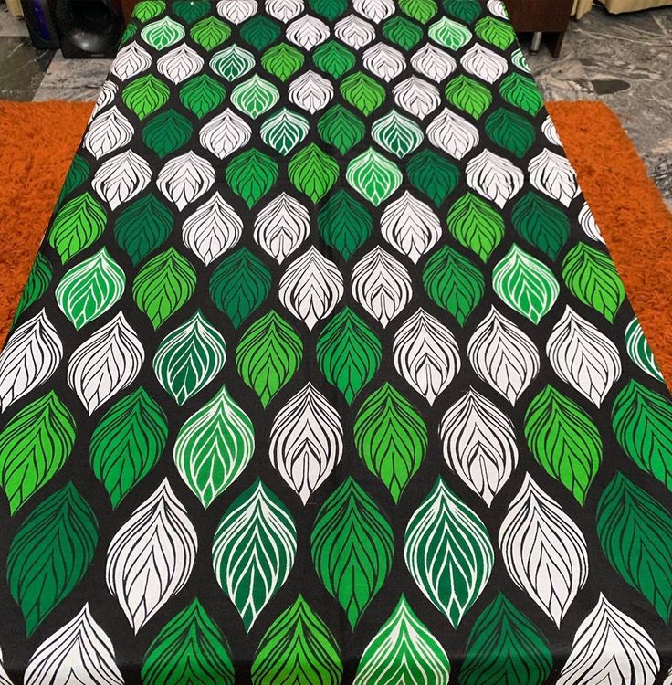 a bed covered in a green and white bedspread