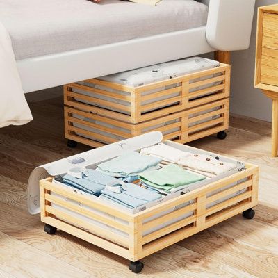 a bed sitting next to a wooden table on top of a hard wood floored floor