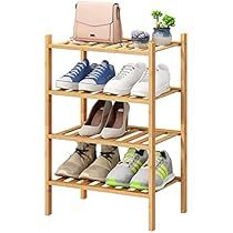 three tier bamboo shoe rack with four pairs of shoes on top and one bag on the bottom