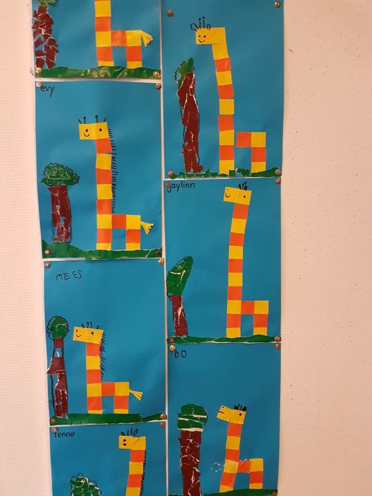 three pieces of paper with legos and giraffes on them, hanging from the wall