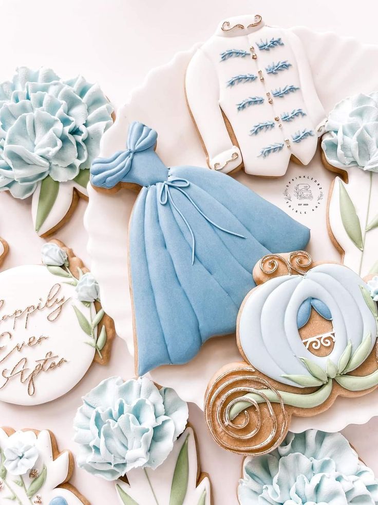 decorated cookies with blue and white frosting are arranged on a table next to each other